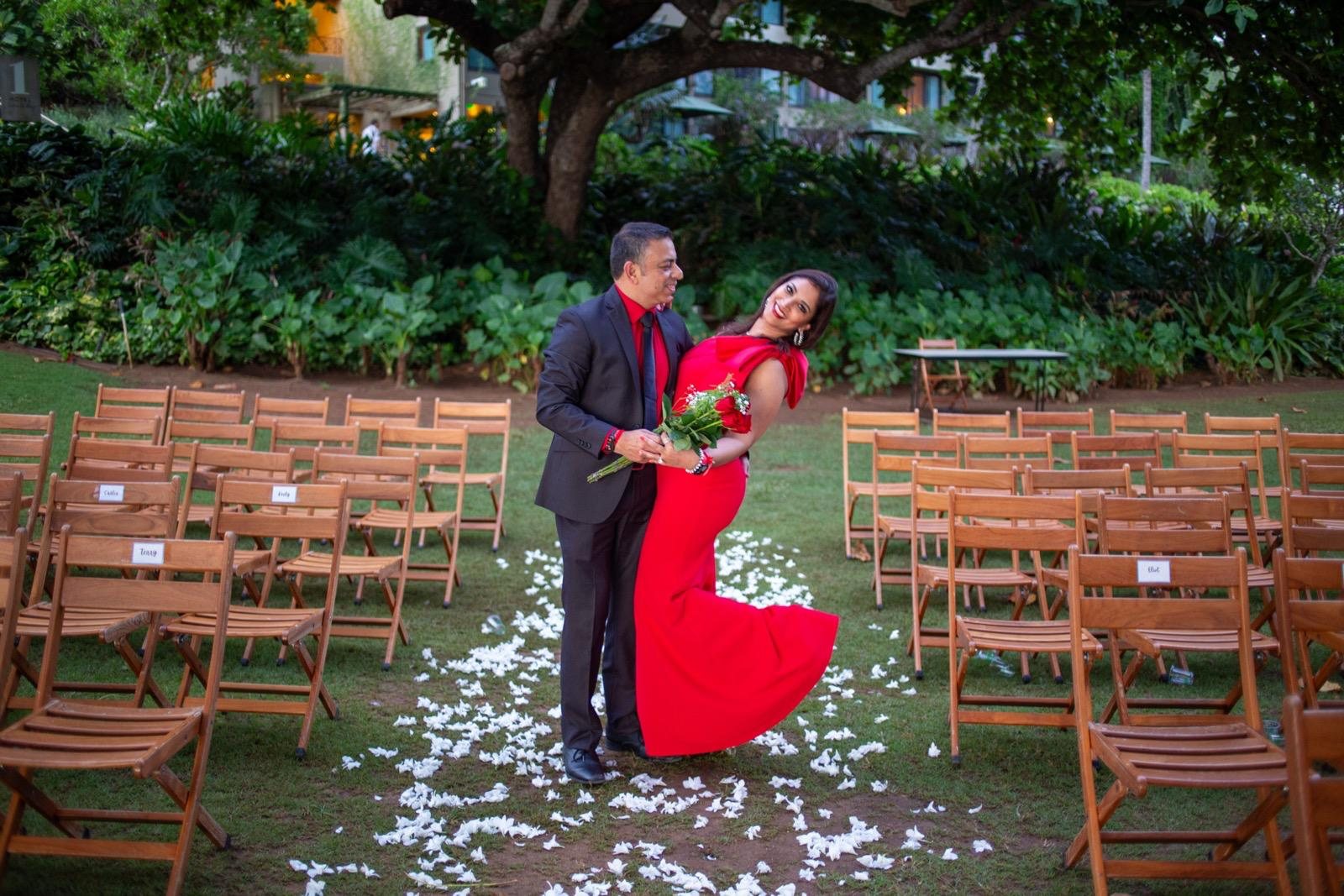 Ankur and Soumya in a garden aisle covered in petals