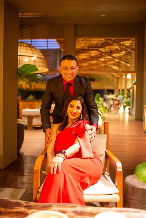 Soumya seated in red with Ankur behind her
