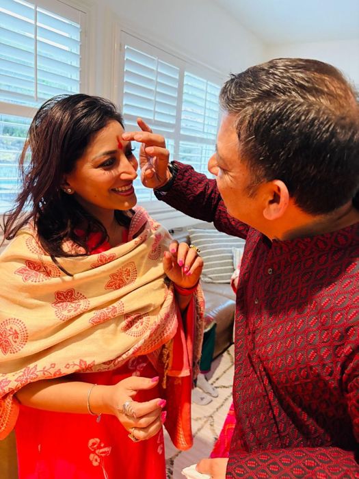 Ankur applying tilak to Soumya